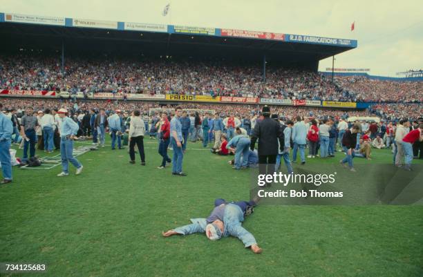 An injured man on the pitch at Hillsborough football stadium in Sheffield, after a human crush at an FA Cup semi-final game between Liverpool and...