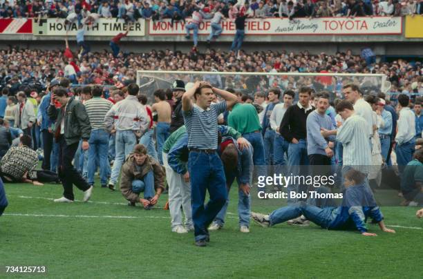 Fans on the pitch at Hillsborough football stadium in Sheffield, after a human crush at an FA Cup semi-final game between Liverpool and Nottingham...