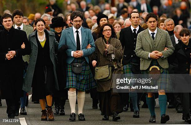 Family members and friends of Chief of Clan MacLeod, John MacLeod walk to the burial ground at the old ruined church at Kilmuir, Dunvegan on the Isle...