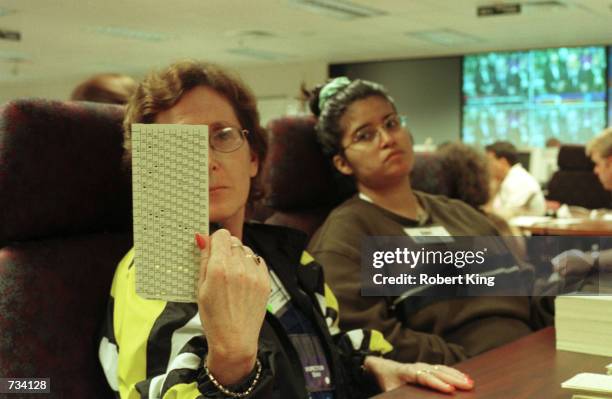 County worker examines a ballot during the manual recount of presidential ballots November 20, 2000 at the Broward County Emergency Operations Center...