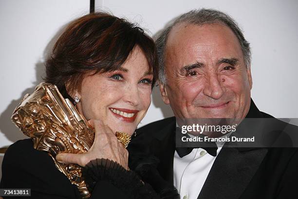 Marlene Jobert poses with her honorary achievement award as she stands next to French actor Claude Brasseur who presented the trophy, during a photo...
