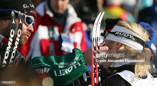 Claudia Kuenzel-Nystad of Germany is comforted by her husband Trond Nystad after the Women Cross Country Pursuit 15 km Classic and Free Event during...