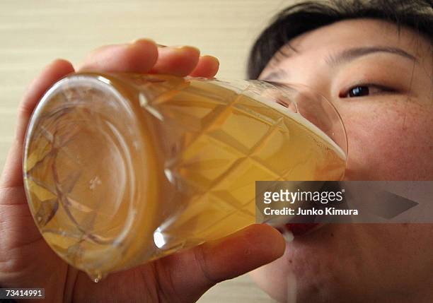 In this photo illustration a woman drinks Bilk, a beer made from milk, on February 25, 2007 in Tokyo, Japan. A liquor shop named Nakahara, on the...