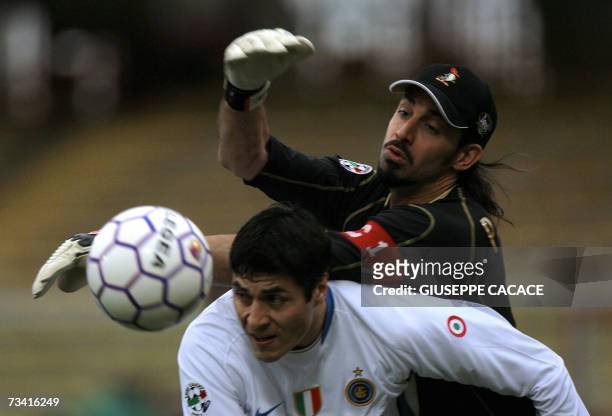 Inter's defender Javier Zanetti of Argentina fights for the ball with Catania's goalkeeper Armando Pantanelli during their Serie A match at "Manuzzi"...