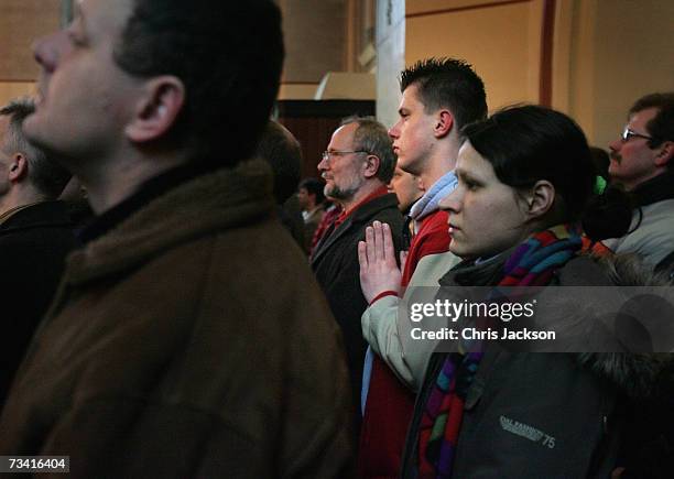 Young man clasps his hands as he prays during a service in St Olaves Church on February 25, 2007 in Oslo, Norway. Many Norwegians attend church on a...