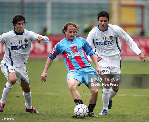 Davide Baiocco of Catania is challenged by Fabio Grosso and Santiago Solari of Inter Milan during the Serie A match between Catania v Inter Milan at...