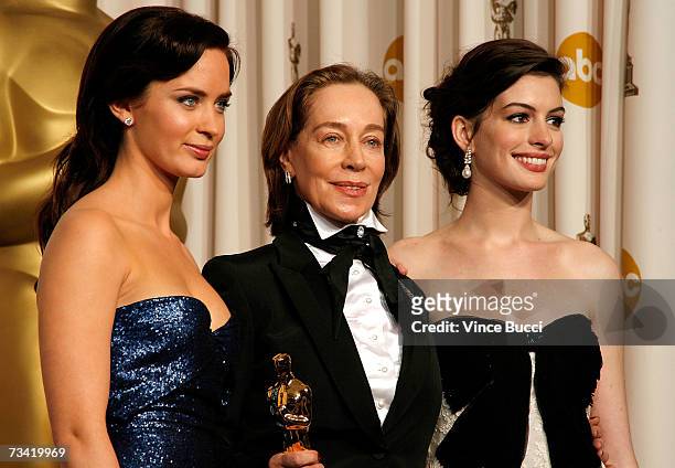 Presenter Emily Blunt, winner of Best Achievement in Costume Design Milena Canonero, and presenter Anne Hathaway pose in the press room during the...