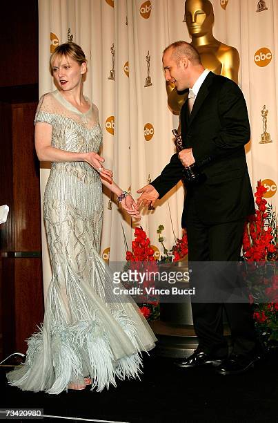 Presenter Kirsten Dunst and Winner of Best Writing, Screenplay Written Directly for the Screen for "Little Miss Sunshine" Michael Arndt pose in the...