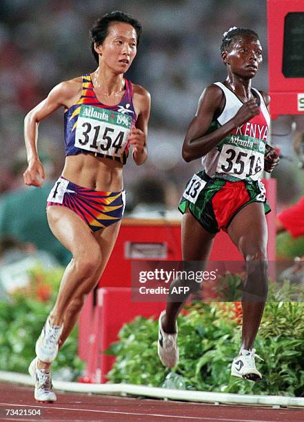 Atlanta, UNITED STATES: This file photo dated 28 July 1996 shows China's Wang Junxia running side by side with Pauline Konga of Kenya during the...