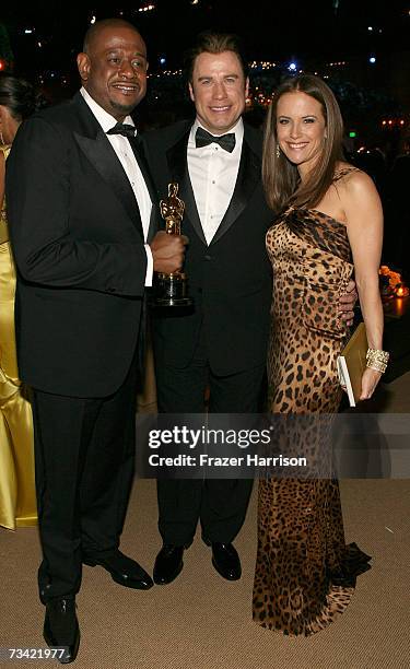 Forest Whitaker poses with his award for Best Actor with actors John Travolta and Kelly Preston at the Governor's Ball after the 79th Annual Academy...