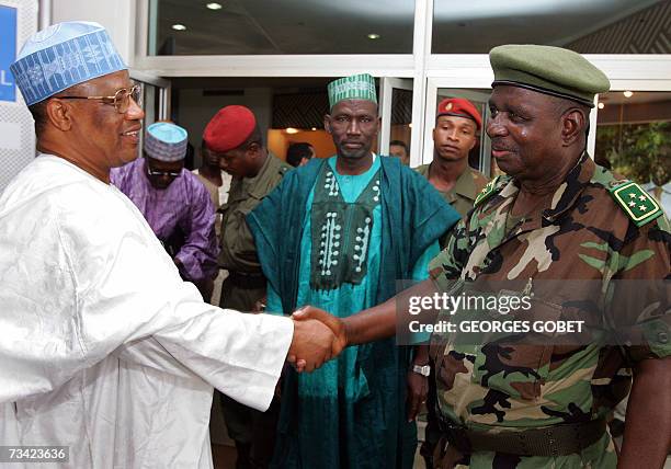 Nigeria's former military ruler Ibrahim Babangida , mediator for the Economic Community of the West African States in the Guinean crisis shakes hands...