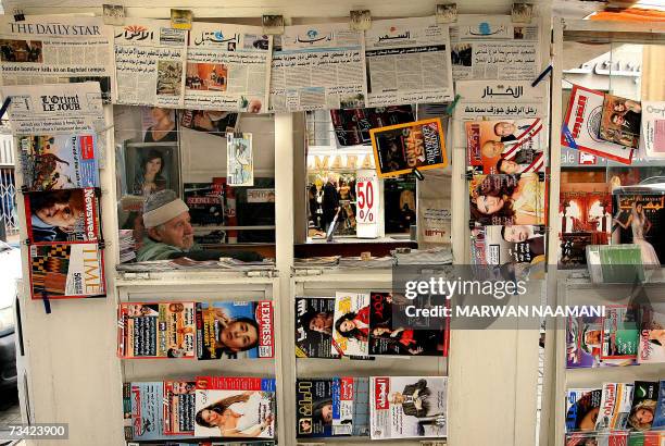 Newspaper vendor sits inside his kiosk, displaying local and international newspapers and magazines in Beirut, 26 February 2007. Iran denied the...