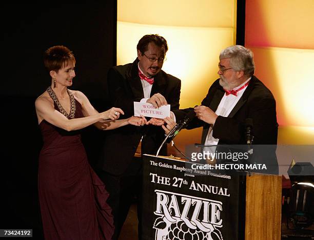 Hollywood, UNITED STATES: Performers deliver the enveloppe to presenter John Wilson for the winner of "Worst Picture", the movie "Basic Instict 2"...