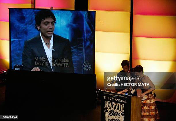Hollywood, UNITED STATES: A clip of the winner for "Worst Director", Night Shyamalan for his movie "Lady in the Water" is displayed next to...