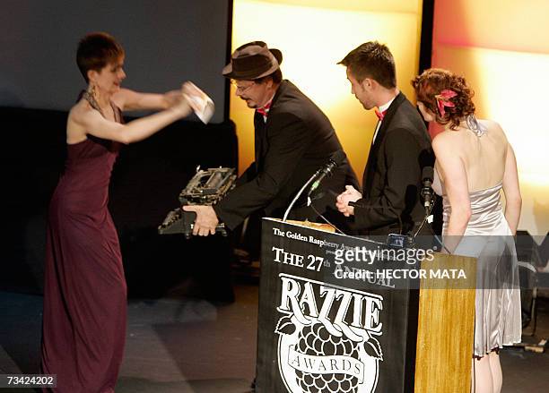 Hollywood, UNITED STATES: Performers deliver the name of the winner for the Worst Screenplay, Leora Barish and Henry Bean for their work in "Basic...