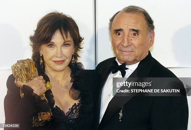 French actress Marlene Jobert, holding her cesar of honnor, poses with French actor Claude Brasseur, president of the 32nd Cesar, during this...