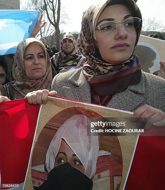 Iraqi Turkmen women hold pictures during an anti-Iraqi government protest in Istanbul 25 February 2007 of a woman who was raped in Talafar, Iraq,...