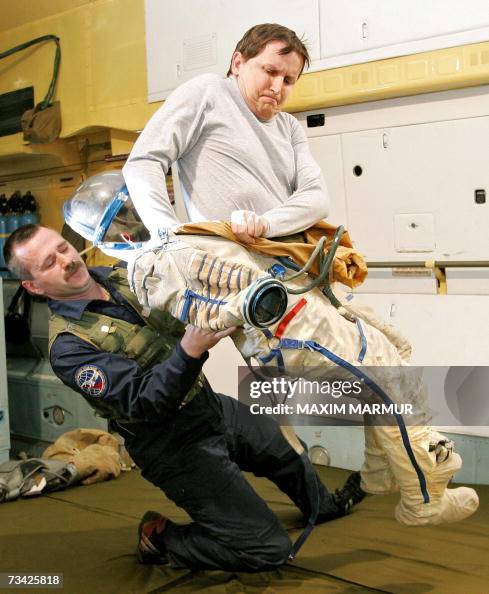 A russian instructor (L) assists former A russian instructor (L) assists former