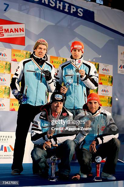 Ronny Ackermann, Sebastian Haseney, Tino Edelmann and Bjoern Kircheisen of Germany take Silver during the FIS Nordic World Ski Championships Nordic...