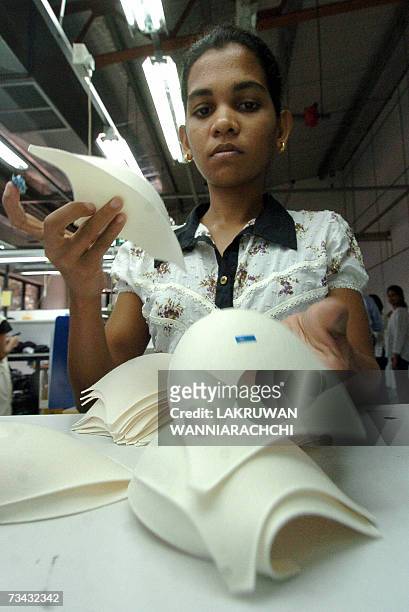 In this picture taken 19 February 2007, A Sri Lankan factory worker sorts cups to be used in the manufacture of brassieres. For some engineers in...