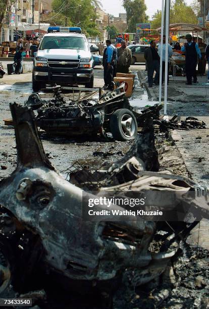 Iraqi policemen secure the site of a car bomb explosion on February 27, 2007 in the Karrada Shiite neighborhood in Baghdad, Iraq. At least two people...