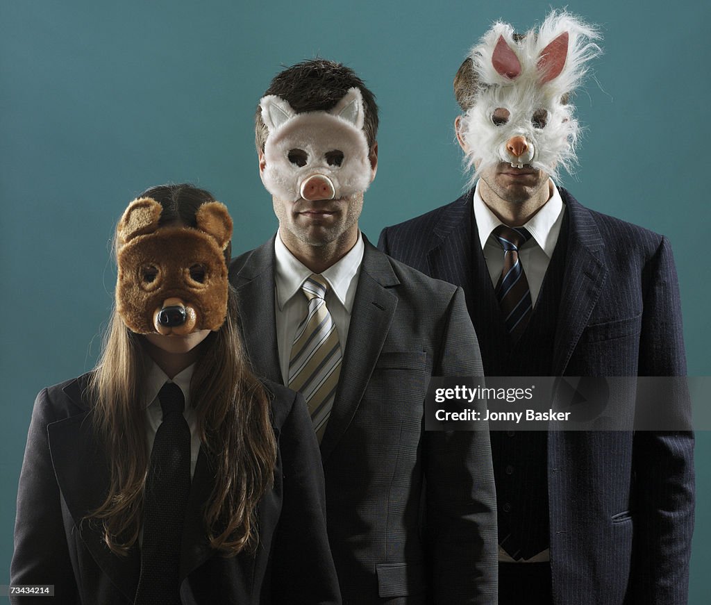 3 people in suits wearing animal masks