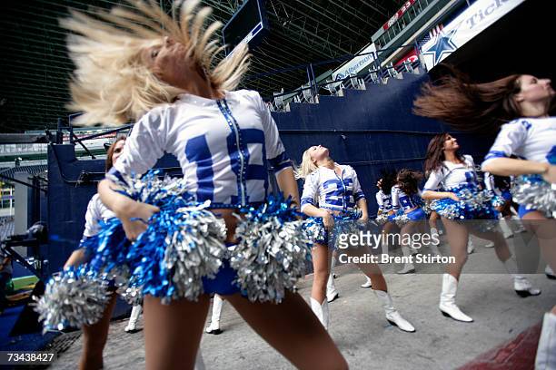 The Dallas Cowboys Cheerleaders warm up before supporting the Dallas Cowboys Football team, in a match against the Washington Redskins at Texas...