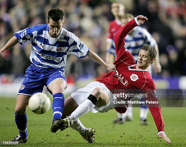 Ole Gunnar Solskjaer of Manchester United clashes with Nicky Shorey of Reading during the FA Cup sponsored by E.ON Fifth Round Replay match between...