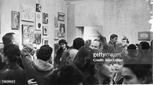 An opening around Christmastime for a group show at the Tanager Gallery, 90 East 10th Street, New York, late 1950s or early 1960s.
