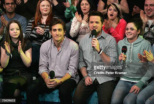Actor Jake Gyllenhaal sits in the audience with MTV VJ Damien Fahey during MTV's Total Request Live at the MTV Times Square Studios on February 27,...