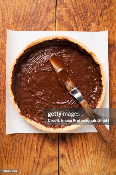 spreading pastry case with chocolate - pastry case stock pictures, royalty-free photos & images