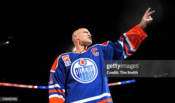 Former Edmonton Oilers great Mark Messier salutes his fans as he takes a final skate around the ice during a ceremony to raise his banner to the...