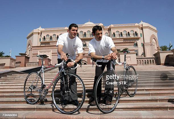 Abu Dhabi, UNITED ARAB EMIRATES: Spanish Melchor Mauri and Abraham Olano pose with their bicycles outside the Emirates Palace hotel in Abu Dhabi 28...