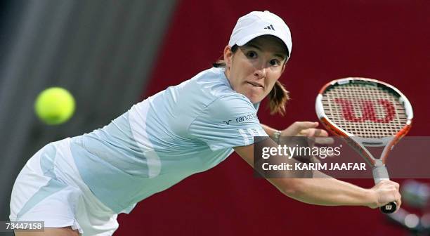 Justine Henin of Belgium returns the ball to Alicia Molik of Australia during their tennis match on the third day of the WTA Qatar Total Open in...