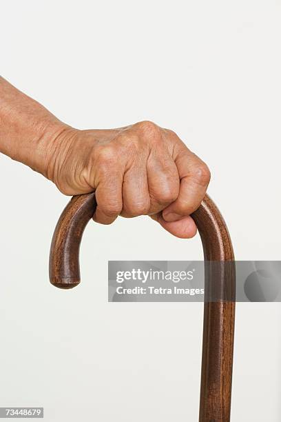 close up of senior's hand on cane - cane ストックフォトと画像