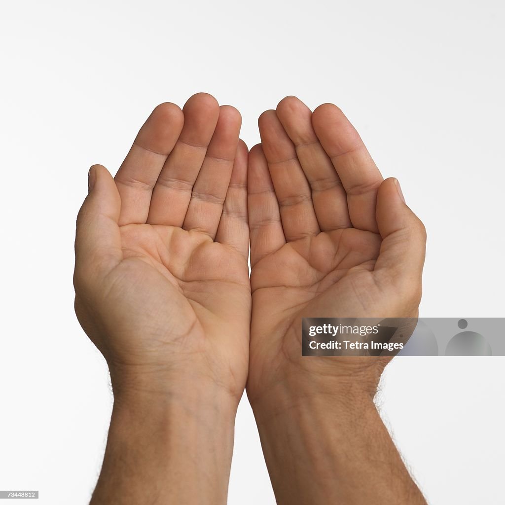 Close up studio shot of man's cupped hands
