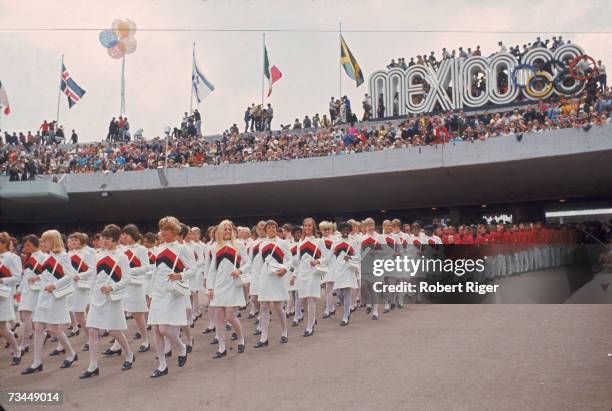 The women of the United States Olympic team lead their male counterparts into the University City Olympic Stadium during the opening ceremonies of...