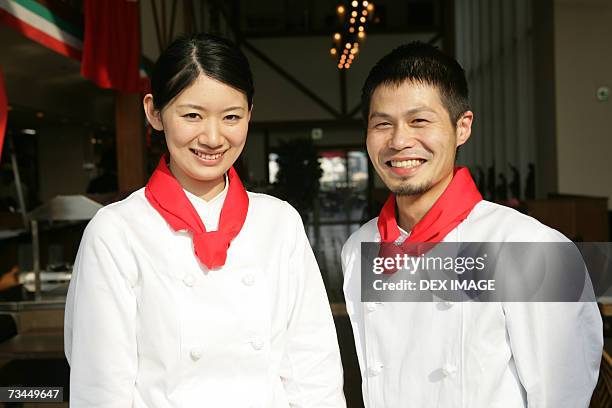 portrait of two chefs standing in a restaurant and smiling - neckerchief stock pictures, royalty-free photos & images