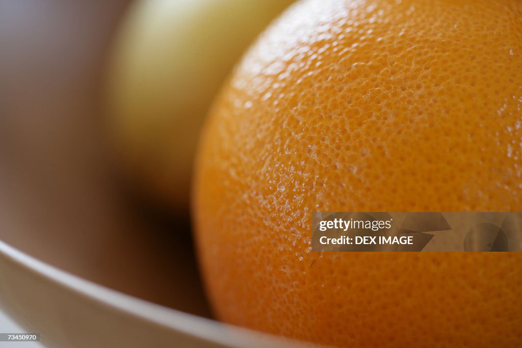 Close-up of an orange in a fruit bowl