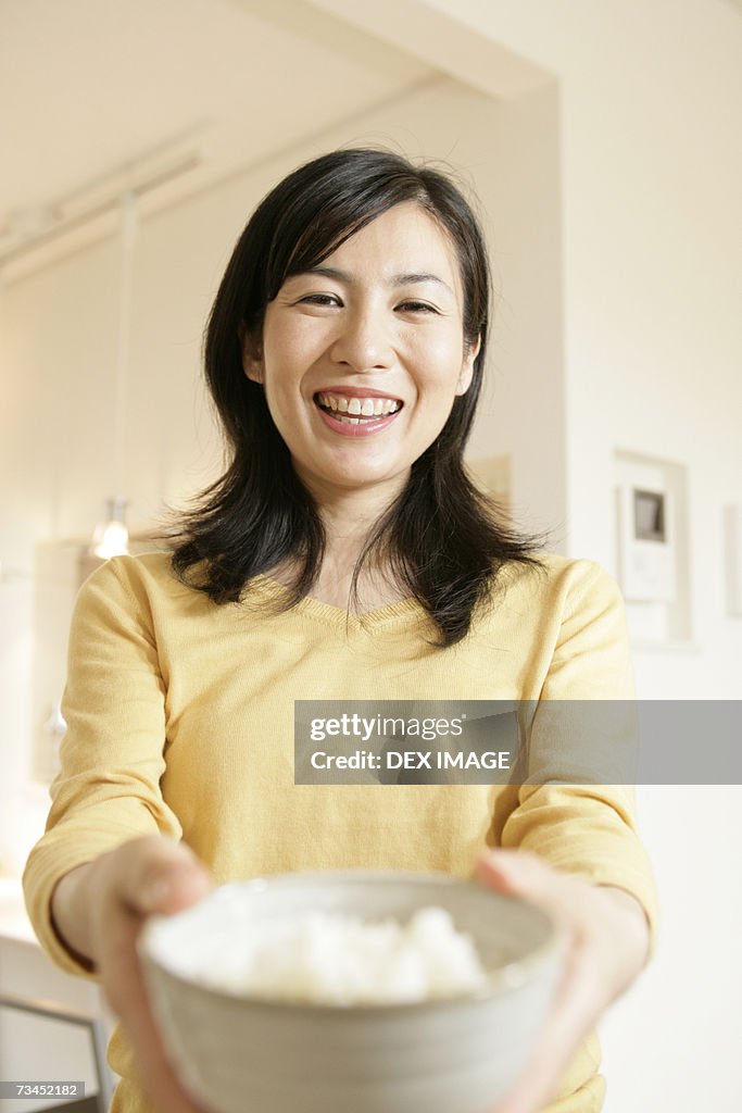 Portrait of a mid adult woman holding a bowl
