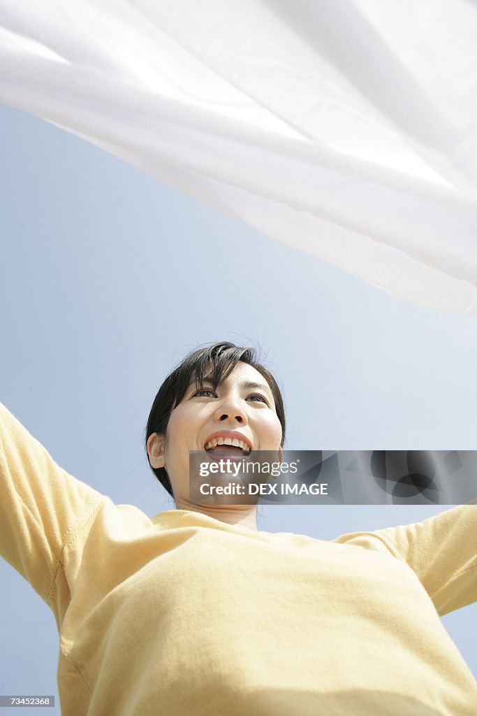 Low angle view of a mid adult woman with her arm outstretched