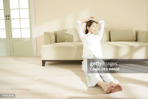 young woman sitting on the floor and smiling - pj soles stock pictures, royalty-free photos & images