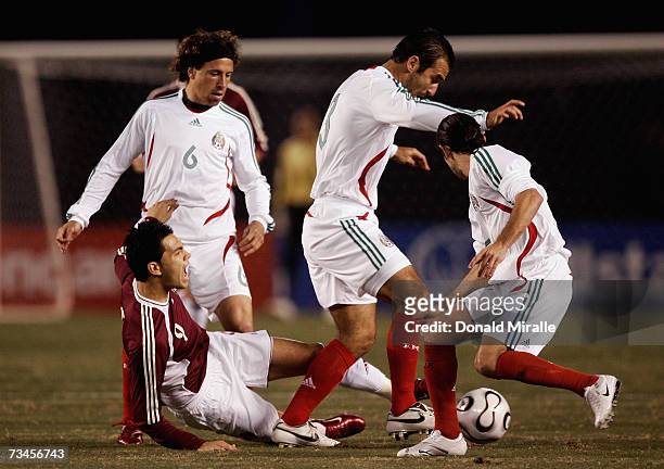 Nicolas Fedor of Venezula has the ball taken away from him by the Mexico defense during the first half of the Mexico v Venezula friendly match on...