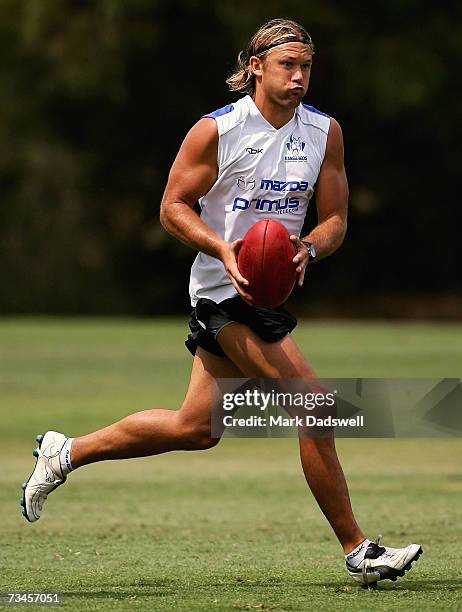 Jess Sinclair of the Kangaroos kicks to a teammate during the clubs AFL training session at Trinity Grammar School on March 1, 2007 in Melbourne,...