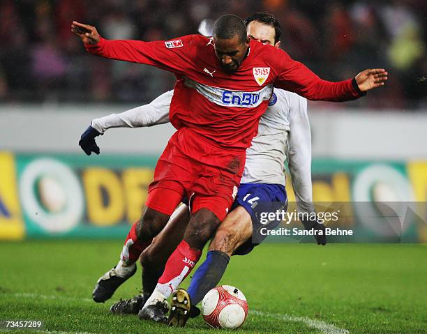 Cacao of Stuttgart is challenged by Josip Simunic of Hertha during the DFB German Cup quarter final match between VfB Stuttgart and Hertha BSC Berlin...