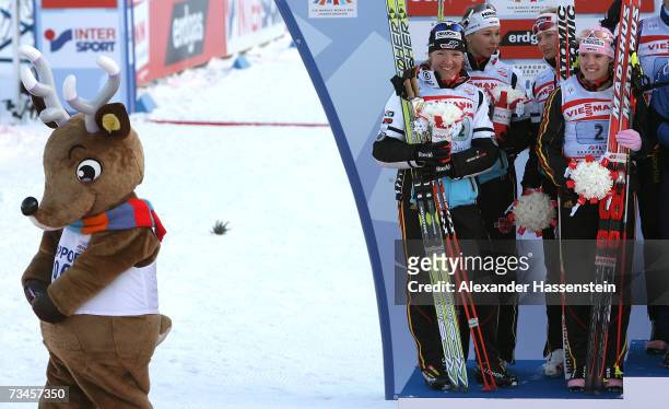 Viola Bauer, Stefanie Boehler, Claudia Kuenzel-Nystad and Evi Sachenbacher Stehle of Germany looking at mascott Norkey from the podium during the...
