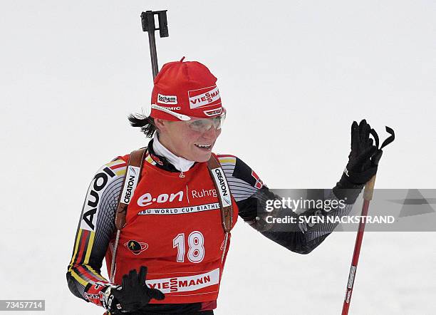 Lahti , FINLAND: Andrea Henkel of Germany gestures as she crosses the finish line to win the IBU Womens 15 km Biathlon in Lahti, Finland, 28 February...