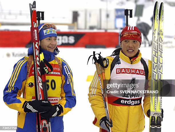 Lahti , FINLAND: Chinese Xianying Liu , fifth placed, stands next to overall World Cup leader Anna Carin Olofsson after the IBU Women 15 km Biathlon...