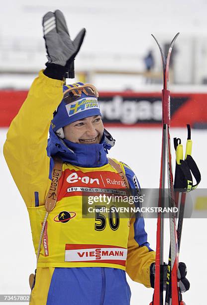 Lahti , FINLAND: Overall World Cup leader Swede Anna Carin Olofsson waves after her fourth place in the IBU Women's 15 km Biathlon in Lahti, Finland,...