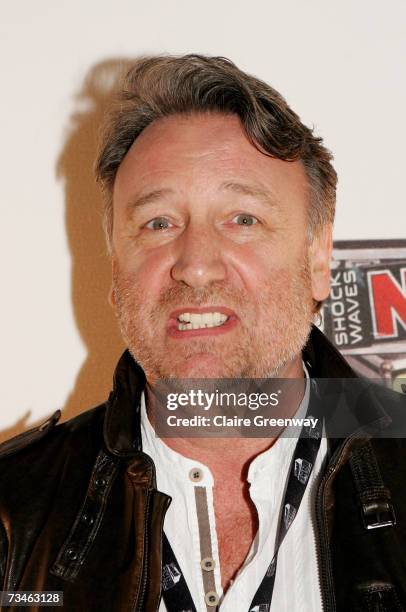 New Order member Peter Hook poses in the awards room at the Shockwaves NME awards at the Hammersmith Palais on March 1, 2007 in London, England.